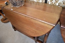An early 20th century gateleg dining table having turned frame