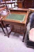 A Victorian mahogany davenport desk having raised back and turned supports