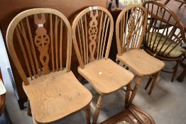 A group of three vintage wheel back chairs, of traditional form