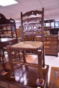 A traditional ladder back kitchen chair having rush seat