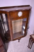 A mid 20th Century walnut china cabinet, having clock inset (Smiths) height approx. 112cm