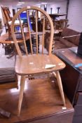 A 1960's Ercol light elm stick/hoop back chair, impressed BS JK mark to underside
