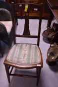 An Arts and Crafts style stained frame bedroom chair with heart motif