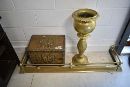 An adjustable brass fender, kindling box and torchere/jardiniere stand