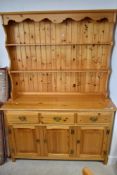 A vintage pine kitchen dresser, width approx. 134cm, height 186cm (splits for convenience)