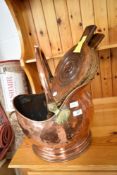 A vintage copper coal helmet and set of bellows