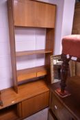 A G Plan teak wall unit comprising base with sliding doors with double shelves over, width approx.