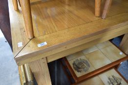 A modern oak extending dining table of square form