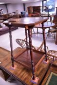 A Victorian mahogany occasional table having canted top on turned splay legs, with galleried