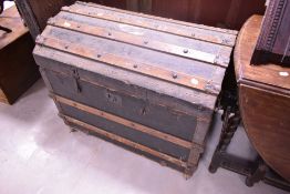 A vintage dome top travel trunk, mounted on castors, width approx. 85cm