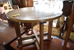 An early 20th Century golden oak circular coffee table in the Arts and Crafts design, diameter
