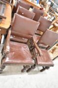 A set of five late 19th or early 20th Century heavy carved dining chairs having vinyl seats and