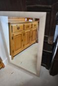 A large modern framed wall mirror, of rectangular form 104cm x 72cm