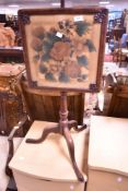 A 19th century mahogany pole screen, the printed material screen within a moulded frame and under
