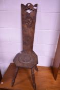 A traditional stained frame spinning chair having rosette decoration