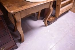 A Continental walnut side table, the moulded rectangular top over pronounced square section cabriole