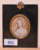 19th Century School, a portrait miniature of a woman with white headdress, set within an ebonised