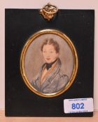 19th Century School, a portrait miniature of a young gentleman wearing a blue overcoat, set within