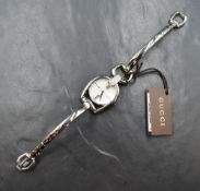 A lady's Gucci steel and diamond horse bit wrist watch, model YA139504, having a mother of pearl