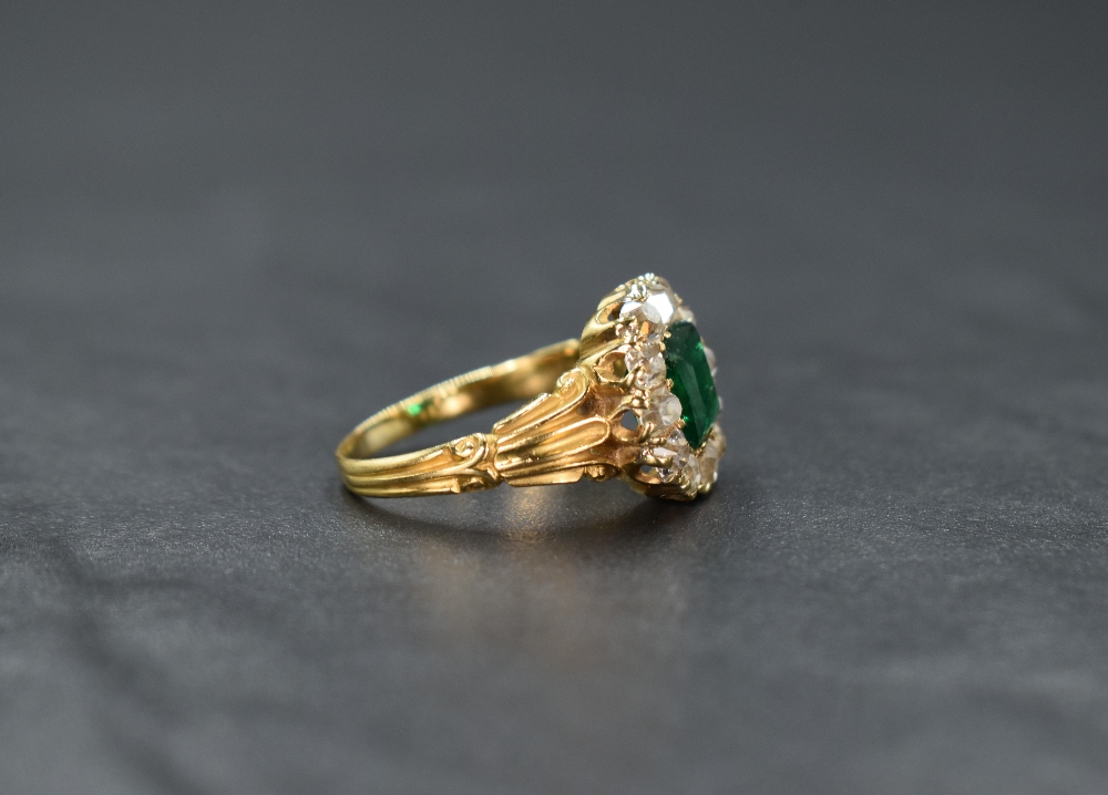 A yellow metal presumed gold emerald and diamond cluster ring, the central mixed cut emerald - Image 2 of 3