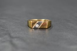 A 9ct gold signet style ring, the horizontal yellow gold panel set with a diagonal white gold band