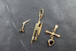 A modern 9ct gold and sapphire pendant, the vertical gold bars set with two sapphire chips, along