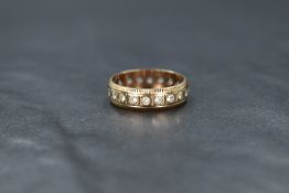 A 9ct gold full eternity band style ring having inset white paste stones, size L & approx 2.7g