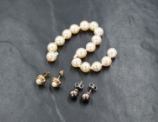 A pair of black pearl stud earrings, mounted on 18ct white gold posts, sold along with a pair of 9ct