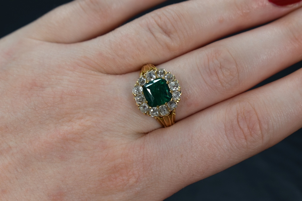 A yellow metal presumed gold emerald and diamond cluster ring, the central mixed cut emerald - Image 3 of 3