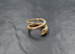 A 9ct gold serpent ring having ruby set eyes, size O & approx4.1g