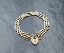 A 9ct gold three bar gate bracelet having padlock clasp, approx 190mm long & 8.5g