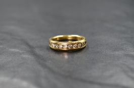 An 18ct gold half eternity ring having ten small brilliant cut diamonds in a channel setting,