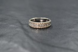 A 14ct white gold diamond band, the central eleven princess cut diamonds measuring approximately 1.