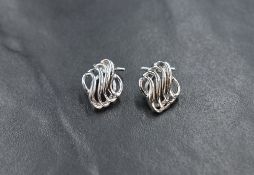 A pair of 9ct white gold clip earrings swirl wire decoration, approx 2.7g