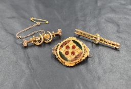 Three yellow metal brooches presumed to be gold, comprising a horseshoe motif bar brooch, a seed
