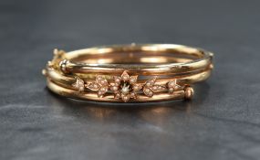 A yellow metal presumed gold and seed pearl hinge bangle, the hollow gold tubes having seed pearl