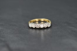 An 18ct gold diamond half eternity ring, having six claw set diamonds, total approx 1ct on an 18ct