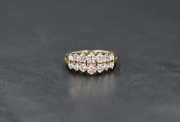 An 18ct gold diamond ring, the two rows of seven graduated round cut diamonds measuring from