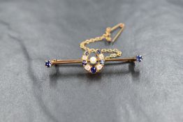 A yellow metal diamond, pearl and blue spinel brooch, the diamond and spinel set horseshoe having