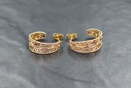 A pair of 9ct gold stud hoop earrings having pierced floral decoration, approx 3.2g