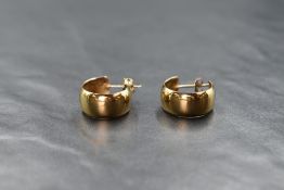 A pair of 9ct gold hoop earrings, of thick rounded form having stud posts, 2.5g