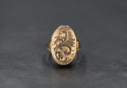A 9ct gold oval locket ring having engraved scroll decoration and moulded shoulders, size P & approx