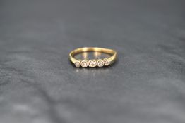 An 18ct gold five stone graduated diamond ring having collared set mounts and knife blade shoulders,
