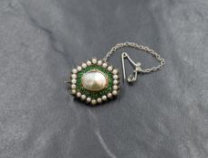 A white metal pearl and green paste brooch, the hexagonal brooch having a central bezel mother-of-