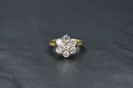 A seven stone brilliant cut diamond daisy cluster ring, total approx 1.35ct in a raised claw set