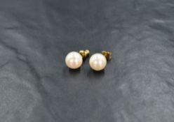 A pair of Christian Dior pearl stud earrings, the imitation pearls on yellow metal posts, 2.1g