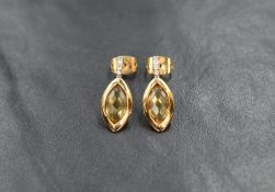 A pair of 9ct gold facet cut citrine earrings in collared mounts below diamond chip set bars, approx