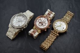 Three Michael Kors wristwatches, comprising one having a white dial, Arabic and square numerals,