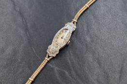 A lady's Art Deco diamond set wrist watch having an Arabic numeral dial to oval face in a diamond
