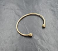 A 9ct gold torque bangle of plain form, internal diameter approx 72mm & 24.5g